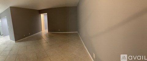 Empty room with tiled floor and white walls.