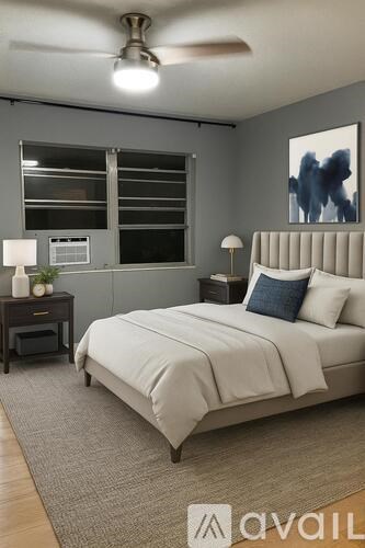 A bedroom with a large bed and a ceiling fan.