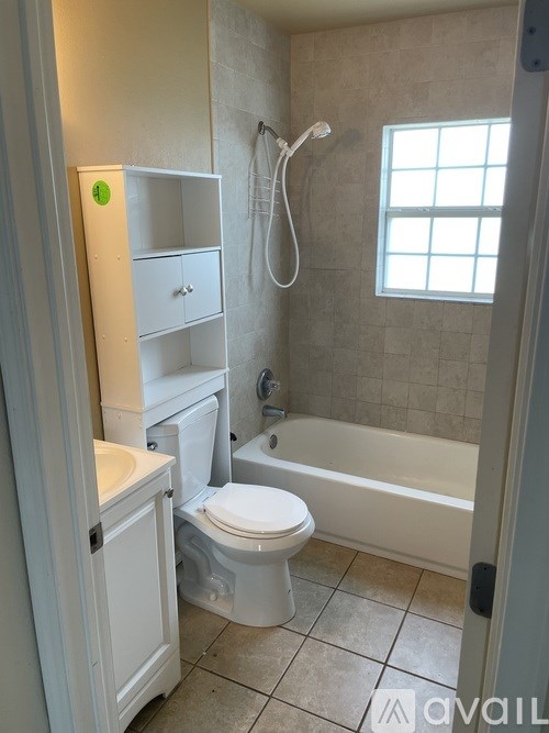 A bathroom with a toilet, sink, and bathtub.