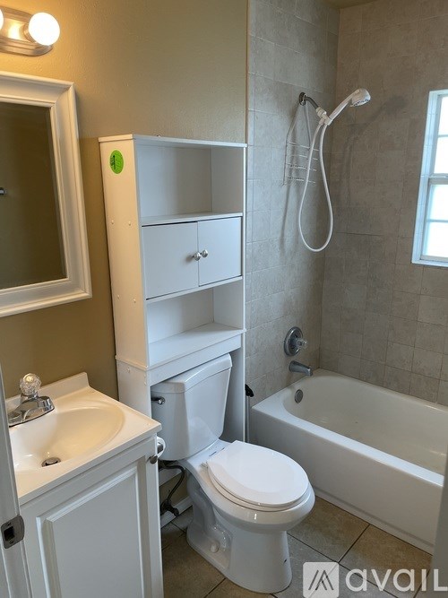 A bathroom with a toilet, sink, and bathtub.
