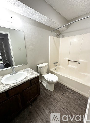 A bathroom with a toilet, sink, and bathtub.
