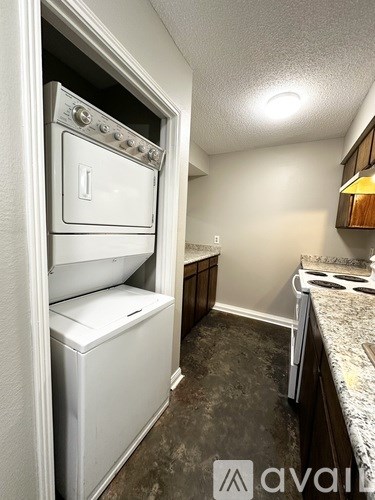 A white oven and dishwasher are built into a wall in a kitchen.