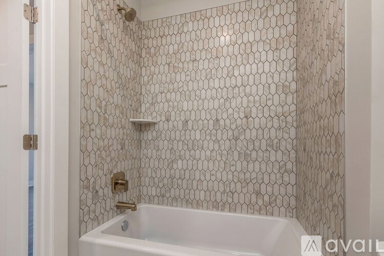 A white bathtub with a shower head and a shower curtain.