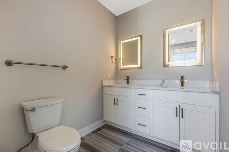 A white toilet sits next to a white sink in a bathroom.