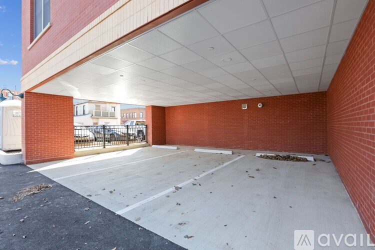 A parking garage with a brick wall and a white ceiling.