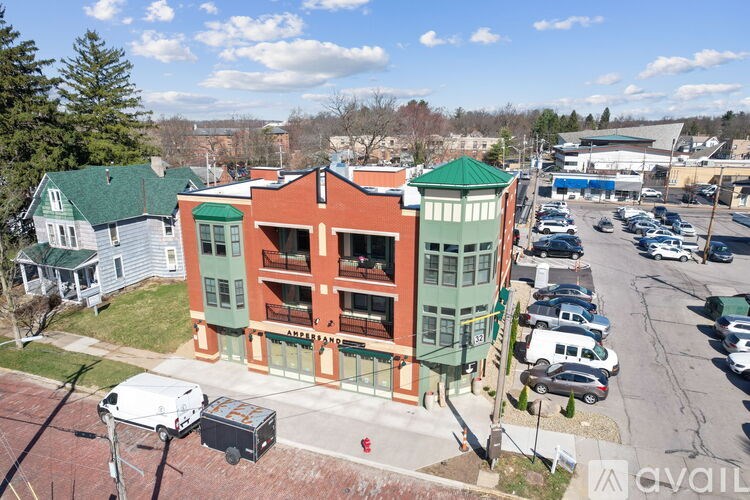A parking lot with cars and a building with a green roof.