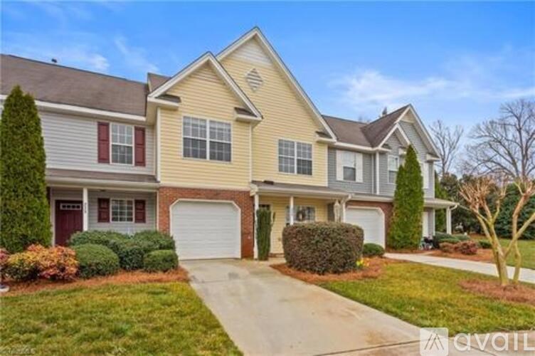 A two-story house with a garage is available for sale.