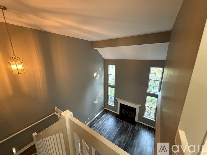 A living room with a fireplace and a chandelier.