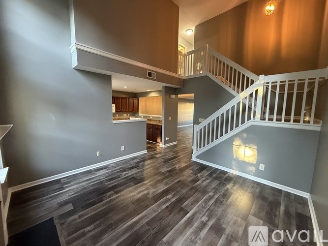 A spacious room with a staircase leading to the upper floor.