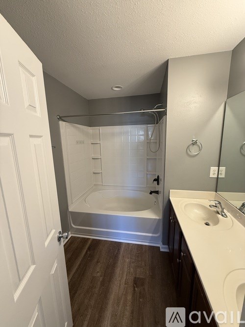 A bathroom with a white sink and a walk-in shower.