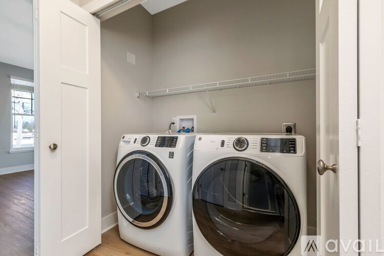 Two front load washing machines in a laundry room.