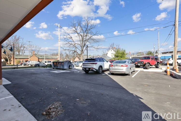 A parking lot with cars and a building in the background.