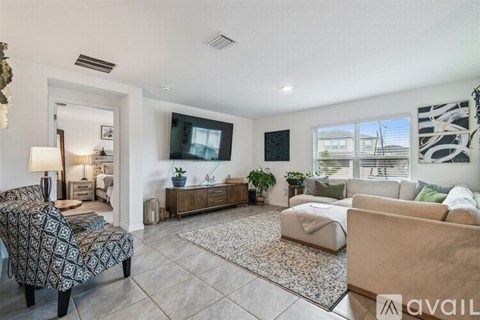 A living room with a patterned sofa and a rug.