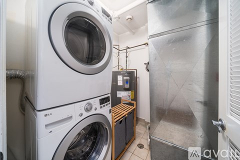 A laundry room with a washer and dryer stacked on top of each other.