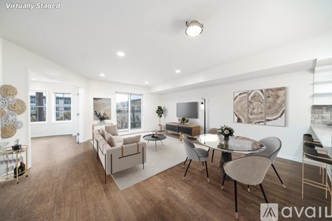 A modern living room with a dining table and chairs.