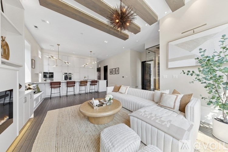 A modern living room with a fireplace and a large mirror on the wall.