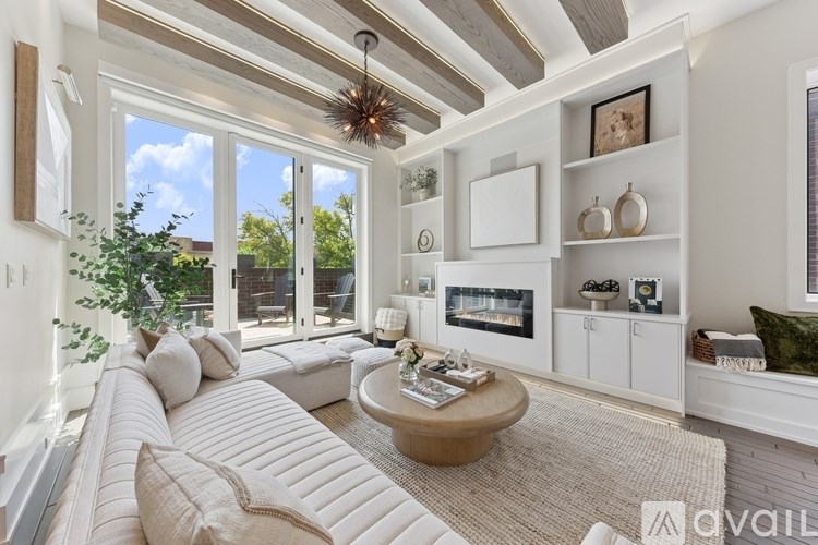 A living room with a white couch and a wooden coffee table.