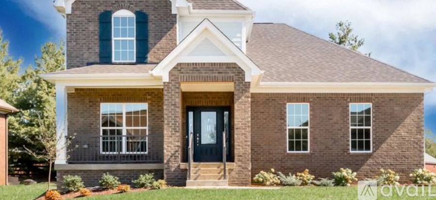 A house with a black front door and windows.