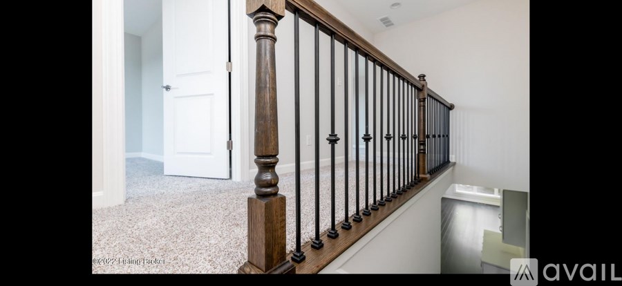 A wooden staircase with a carpeted floor.