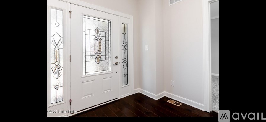 A hallway with a white door and a window.