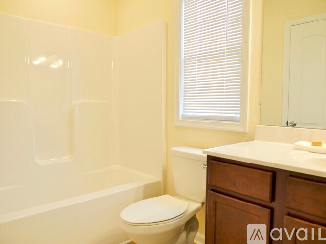 A bathroom with a toilet, sink, and bathtub.