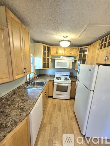A kitchen with wooden cabinets and a washing machine.