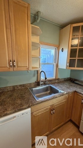 A kitchen with wooden cabinets and a washing machine.