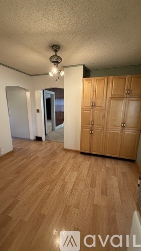 A room with wooden floors and a wall-mounted cabinet.