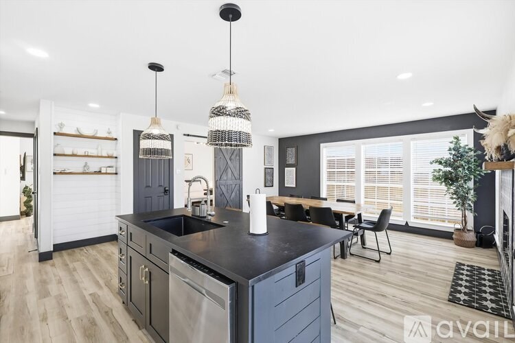 A modern kitchen with a black countertop and a large island.