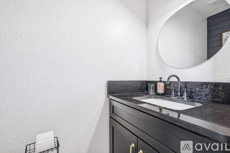 A bathroom with a sink and a mirror.