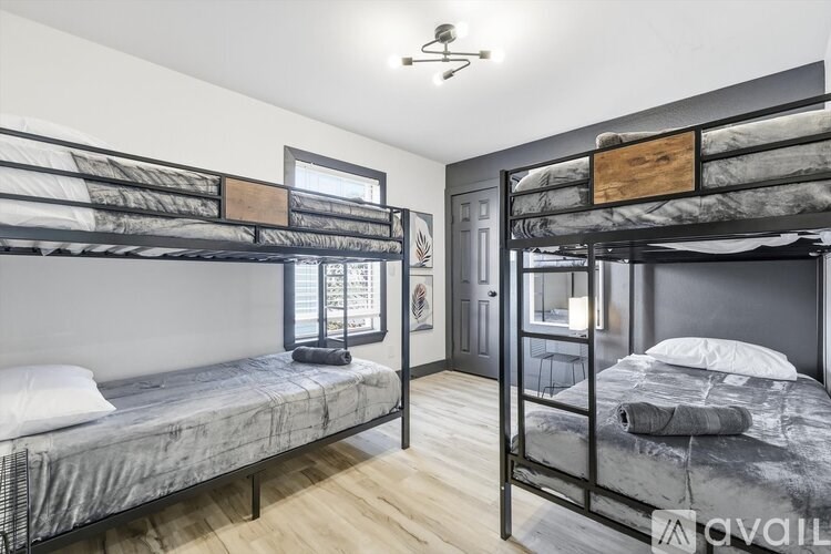 A room with two bunk beds and a door.