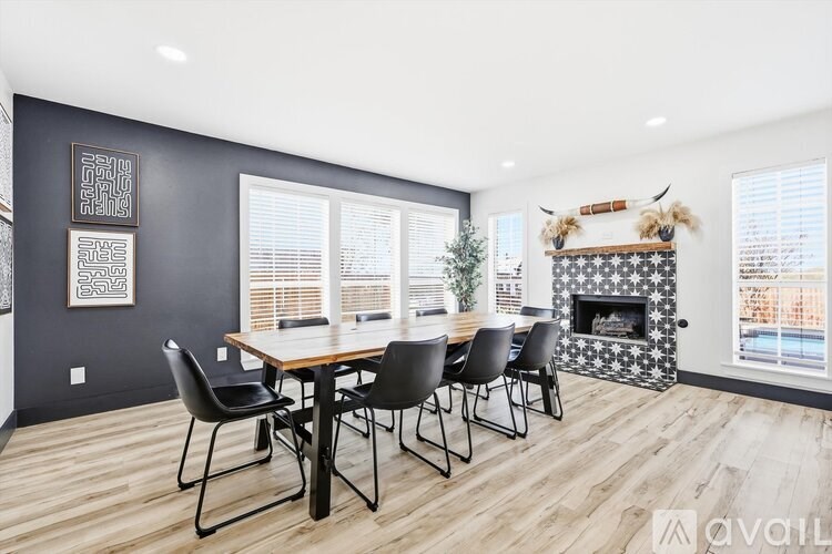 A dining room with a wooden table and chairs.