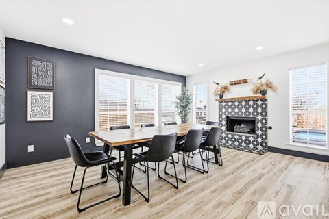 A dining room with a wooden table and chairs.
