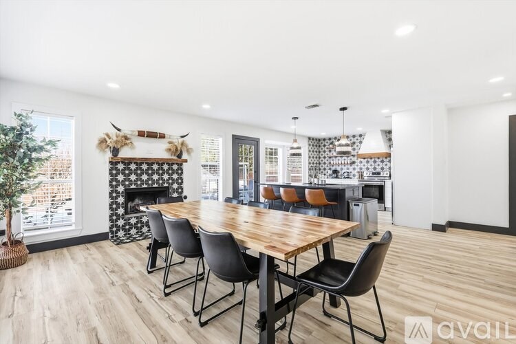 A dining room with a wooden table and chairs.
