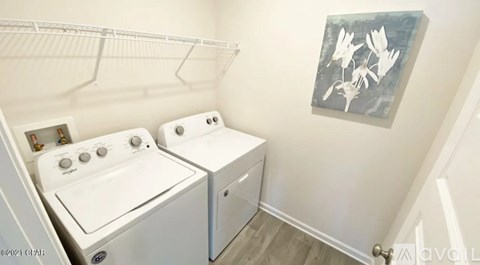 A small laundry room with a washer and dryer.