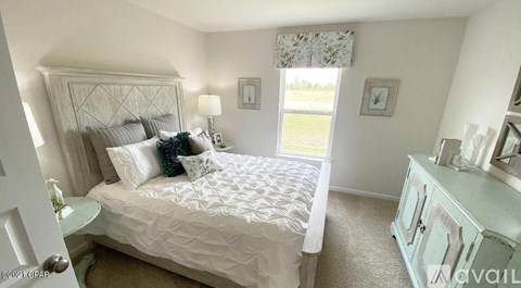 A bedroom with a large bed and a dresser.