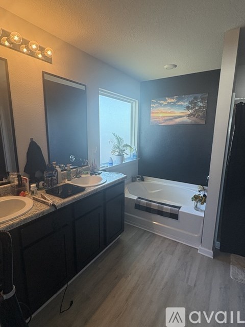 A bathroom with a black and white color scheme and a large mirror.