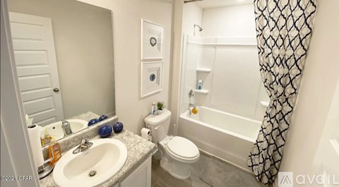 A bathroom with a toilet, sink, and bathtub.