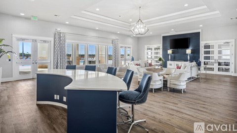 A modern kitchen with a large island and a dining area.