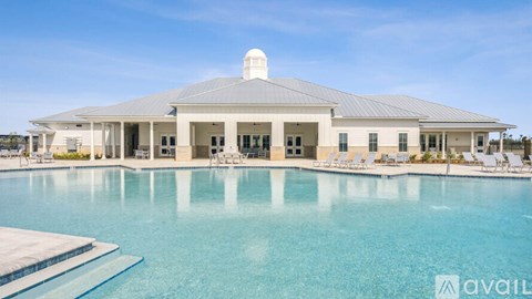 A large building with a pool in front of it.