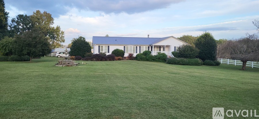 A large house with a white fence in front of it.