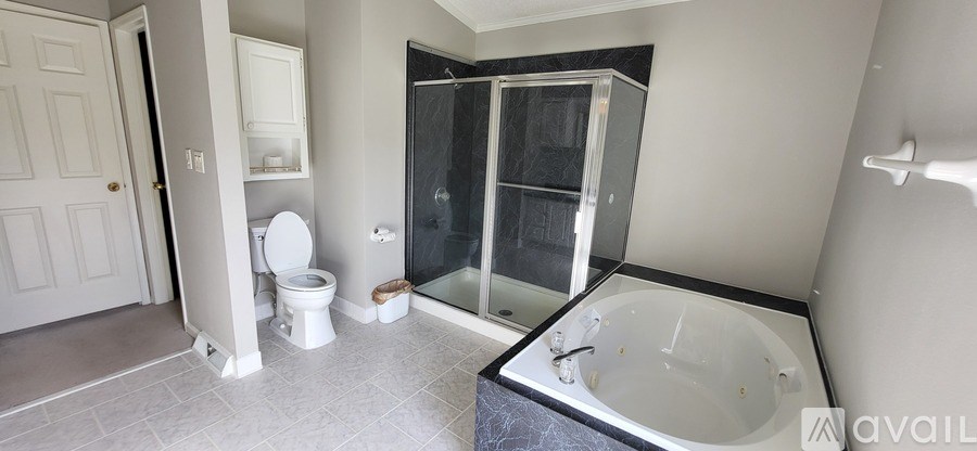 A bathroom with a toilet, sink, and bathtub.