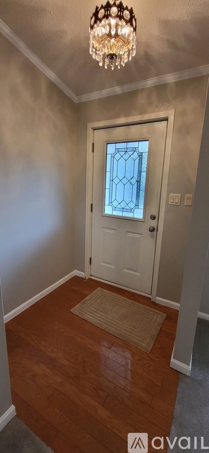 A room with a wooden floor and a white door.