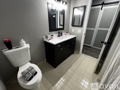 A bathroom with a white toilet and a white sink.
