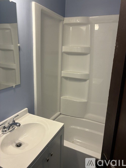 A white sink with a silver faucet in a bathroom.