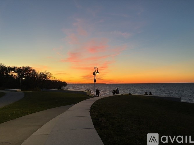 A beautiful sunset view with people enjoying the view at the beach.