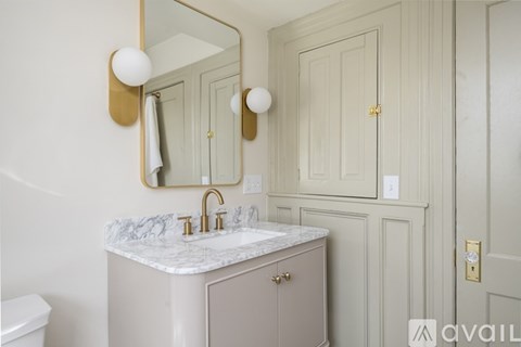A bathroom with a marble countertop and a white toilet.