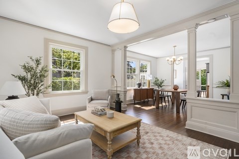 A well-lit living room with a wooden coffee table and a white sofa.