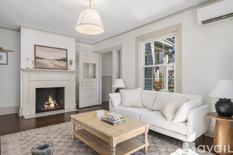 A living room with a fireplace, a couch, and a coffee table.