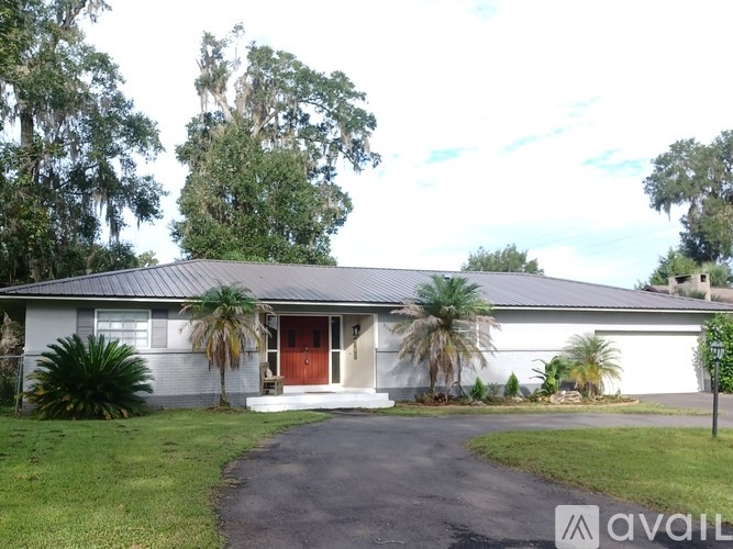 A house with a red door is for sale.